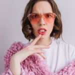 close-up-portrait-unpleased-brunette-woman-sunglasses-making-faces-white-wall-indoor-shot-fashionable-caucasian-girl-pink-fur-coat_197531-5145